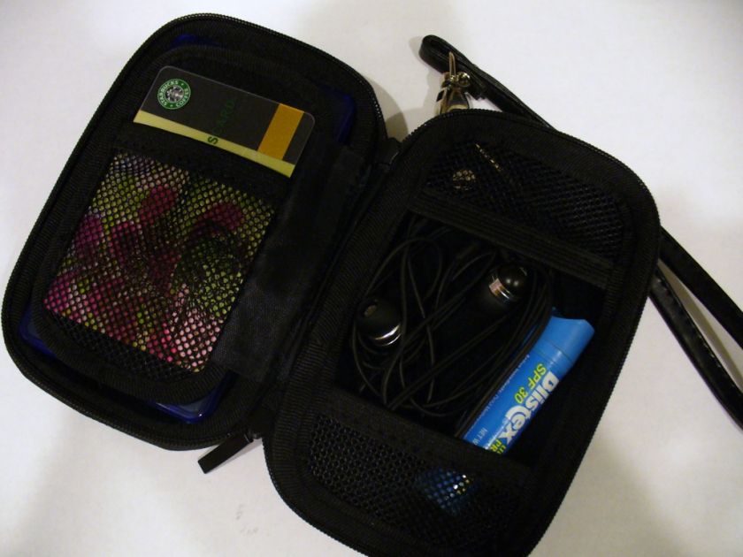 card blistex earbuds in compartments secured by black netting picture 