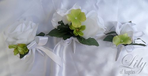 are made with one white rosebud accented with green hydrangeas